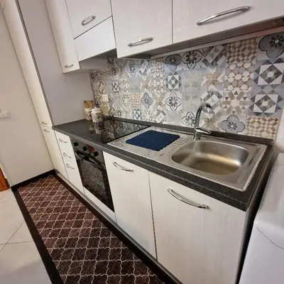 a small kitchen with a sink and a stove at Aspettando Vossia in Palermo