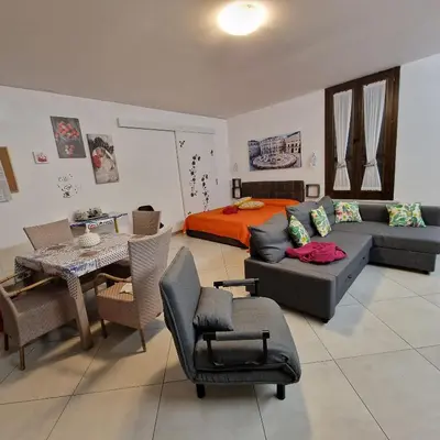 a living room with a couch and a bed at Aspettando Vossia in Palermo