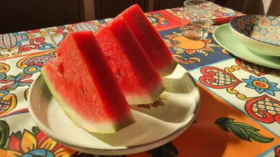 two slices of watermelon on a plate on a table at Casetta delle Mimose in Isola delle Femmine