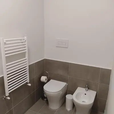 a bathroom with a toilet and a sink at Donna Franca Rooms and Suite in Palermo