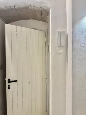 a white door in a room with a white wall at Casetta Mape in Palermo