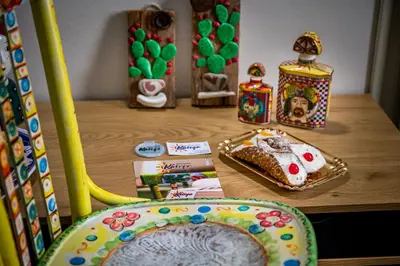 a table with a cake and a plate of food at Kalifè Vacanze in Castellammare del Golfo