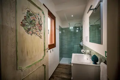 a bathroom with a sink and a shower at Kalifè Vacanze in Castellammare del Golfo
