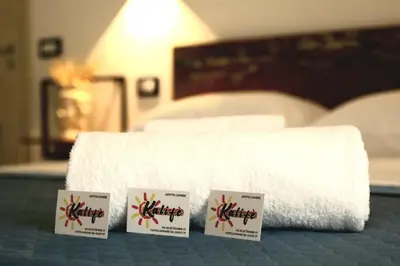 a pile of white towels sitting on a bed at Kalifè Vacanze in Castellammare del Golfo