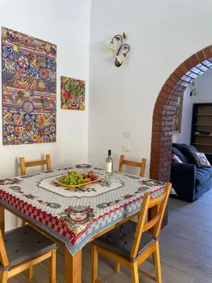 a dining room table with a plate of fruit on it at Casa in piazzetta in Balestrate