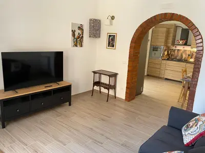 a living room with a flat screen tv sitting on a table at Casa in piazzetta in Balestrate