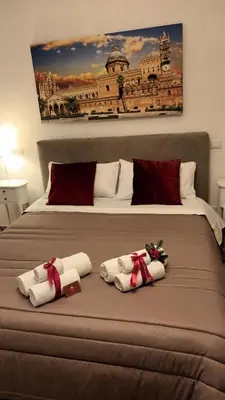a bedroom with a bed with two towels on it at Affittacamere Ammirata in Palermo
