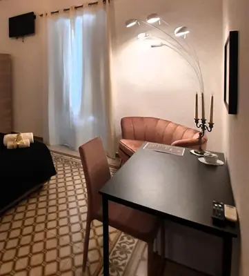 a living room with a table and a couch at Affittacamere Ammirata in Palermo