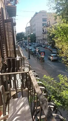 a balcony with benches and a street with cars at Affittacamere Ammirata in Palermo