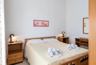 a bedroom with a bed with white towels on it at Casa Vacanza Azzurra 2 in San Vito lo Capo
