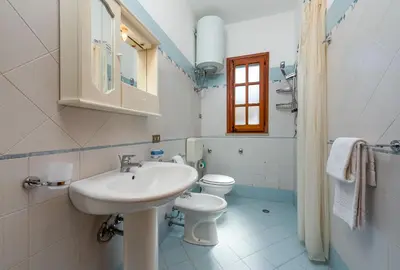 a bathroom with a sink and a toilet at Casa Vacanza Azzurra 2 in San Vito lo Capo