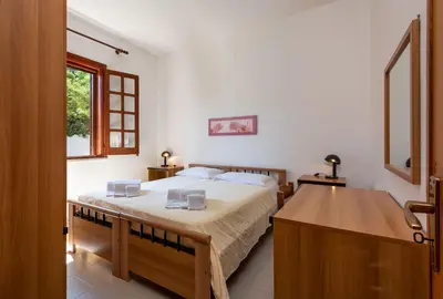 a bedroom with a large bed and a sink at Casa Vacanza Azzurra 2 in San Vito lo Capo