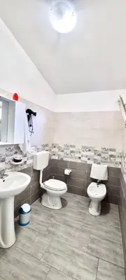 a bathroom with two toilets and a sink at B&B Torre Turrisi in Partinico