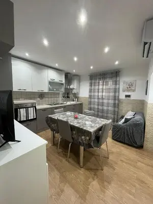 a kitchen and living room with a table and chairs at Casa da Francesca in Palermo