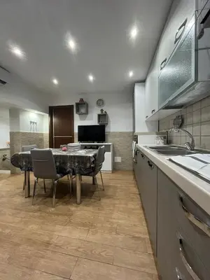 a kitchen with a table and chairs in a kitchen at Casa da Francesca in Palermo