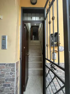 a hallway with a staircase leading to a door at Casa da Francesca in Palermo