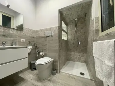 a bathroom with a toilet and a shower and a sink at Goccia del mare in Isola delle Femmine