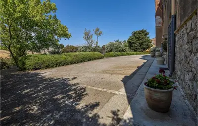 a driveway with a pot of flowers on the side of a building at Acque Di Palermo in Roccapalumba