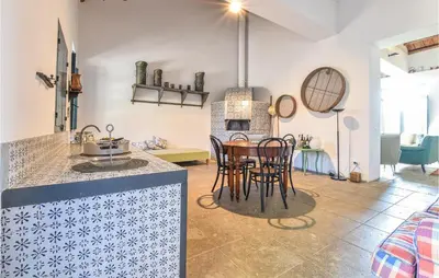 a kitchen and living room with a table and chairs at Acque Di Palermo in Roccapalumba