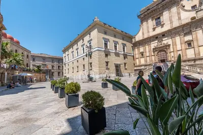 a row of potted plants in front of a building at Suite Bellini 5 Apartment in Palermo