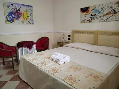 a bedroom with a bed with two towels on it at Hotel Trinacria in Palermo