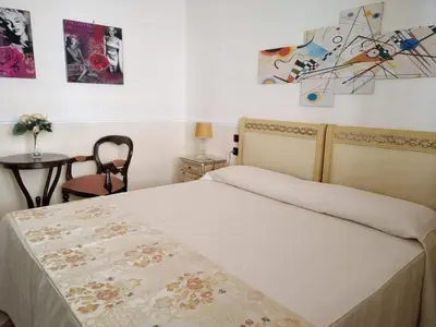 a bedroom with a bed and a table at Hotel Trinacria in Palermo