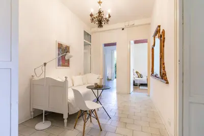 a living room with a table and a couch at GuestHost - Teatro Massimo Bright and Cozy Apartment in Palermo