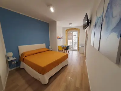 a bedroom with a bed and a blue wall at A casa di Claudia in Palermo