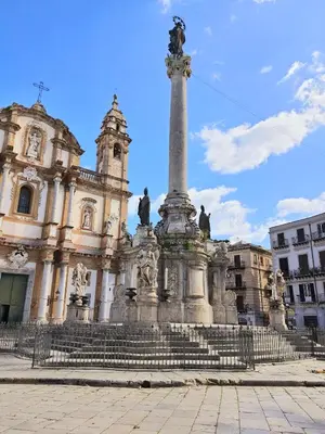a large building with a monument in front of it at A casa di Claudia in Palermo