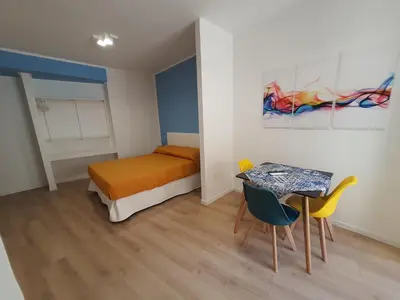 a bedroom with a bed and a table and chairs at A casa di Claudia in Palermo