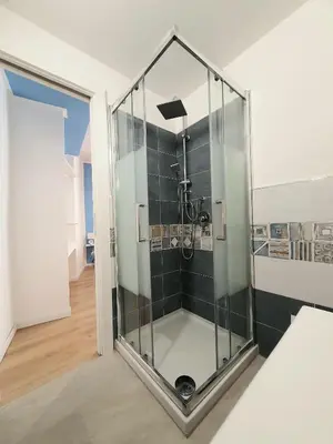 a shower in a room with a glass wall at A casa di Claudia in Palermo