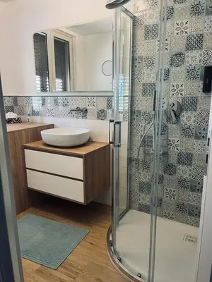 a bathroom with a glass shower and a sink at Casa Levante in Isola delle Femmine