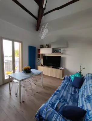 a living room with a table and a couch at Casa Levante in Isola delle Femmine