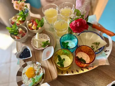 a table topped with bowls of food and drinks at Esmaraldas House of Love in Terrasini