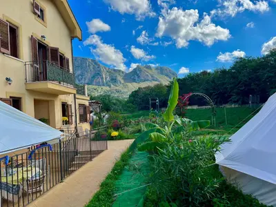 a view of a house with mountains in the background at Esmaraldas House of Love in Terrasini