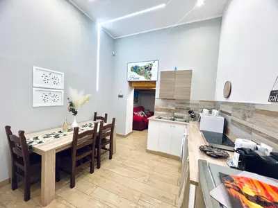a kitchen and dining room with a table and chairs at Giglio Home in Palermo