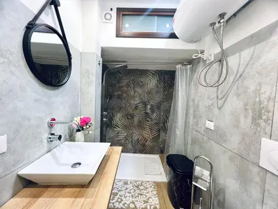 a bathroom with a sink and a mirror at Giglio Home in Palermo