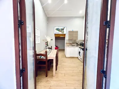 a kitchen and dining room with a table and a dining room at Giglio Home in Palermo