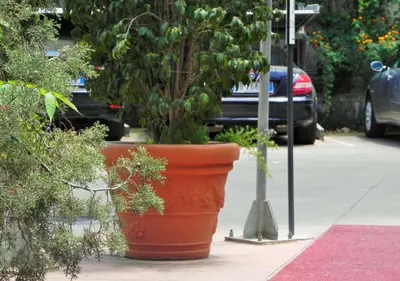 a large orange pot sitting on the side of a street at Torreata Hotel & Residence in Palermo