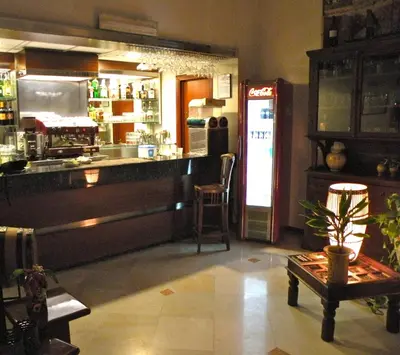 a bar in a restaurant with a counter and a refrigerator at Torreata Hotel & Residence in Palermo