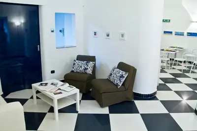 a living room with two chairs and a table at Casa Galati in Palermo