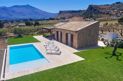a villa with a swimming pool and a house at VILLA DEL BORGO con piscina e jacuzzi in Scopello