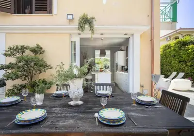 a table with plates and wine glasses on it at Seaside Villa in Carini