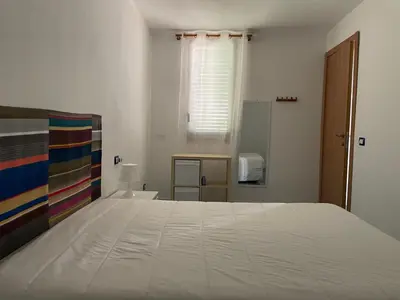 a large white bed in a room with a window at Casa Dorotea in Nuova Gibellina