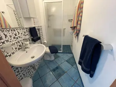 a bathroom with a sink and a shower and a toilet at Casa Dorotea in Nuova Gibellina