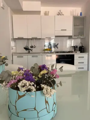 a kitchen with a blue vase with flowers in it at Casa Dorotea in Nuova Gibellina