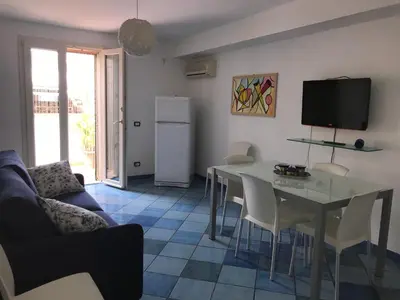 a living room with a table and a tv at Casa Dorotea in Nuova Gibellina