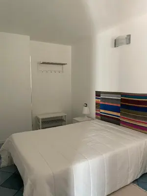 a bedroom with a large white bed in a room at Casa Dorotea in Nuova Gibellina