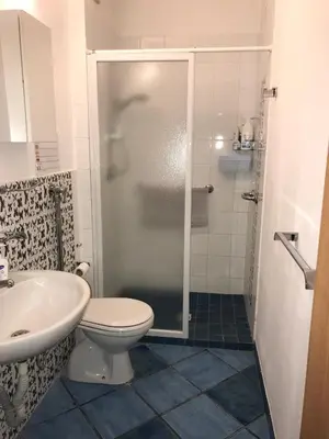 a bathroom with a shower and a toilet and a sink at Casa Dorotea in Nuova Gibellina