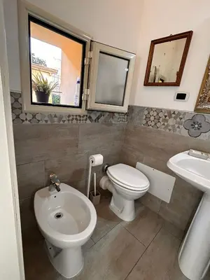a bathroom with a toilet and a sink at Loft Ballarò in Palermo